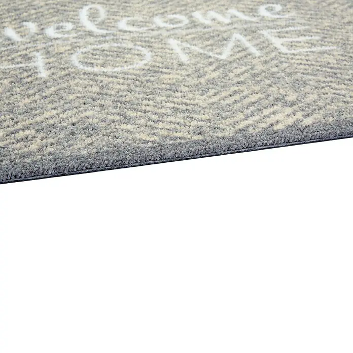 Schmutzfangmatte Miabella - Grau, 70 x 50 cm, 100 % Polyamid - Detailaufnahme einer Fußmatte mit der Aufschrift "Welcome Home" und einem grauen Zickzackmuster.