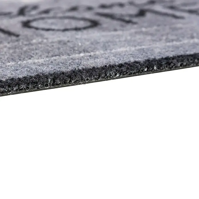 Fußmatte Deco Brush - Beton, 70 x 50 cm, 100 % Polyamid - Detailansicht einer grauen Fußmatte mit schwarzem Rand, die eine robuste und stilvolle Ergänzung für jeden Eingangsbereich darstellt.