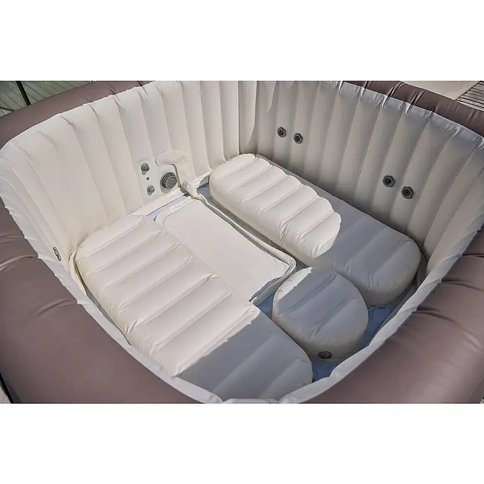 Bestway Lay-Z-Spa Mobil-Whirlpool Copenhagen Hydrojet - L x B x H: 201 x 201 x 80 cm, Grau, 1.050 l - Nahaufnahme eines aufblasbaren Whirlpools mit mehreren weißen Kissen, der Komfort und Entspannung verspricht.