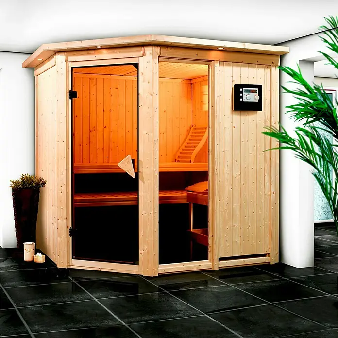 Karibu Elementsauna Fiona - Ohne Ofen, Ohne Dachkranz, L x B x H: 196 x 170 x 192 cm - Hier sehen wir eine Ecksauna mit Glasfront, eingebaut in einem modernen Raum mit dunklen Fliesen. Die Sauna lädt zu Entspannung ein.