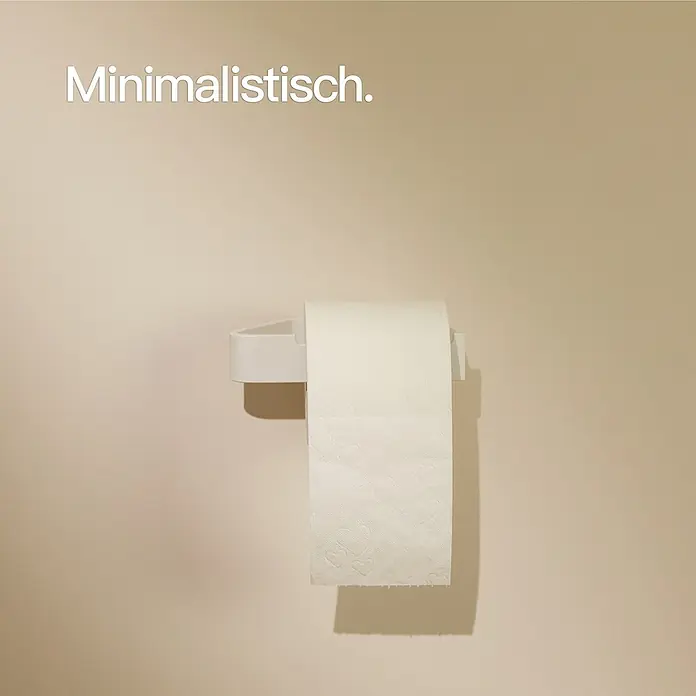 Designfabrik Hamburg Toilettenpapierhalter - Weiß, Matt - Minimalistisch: Eine weiße Toilettenpapierrolle hängt an einem weißen Halter an einer beigen Wand.