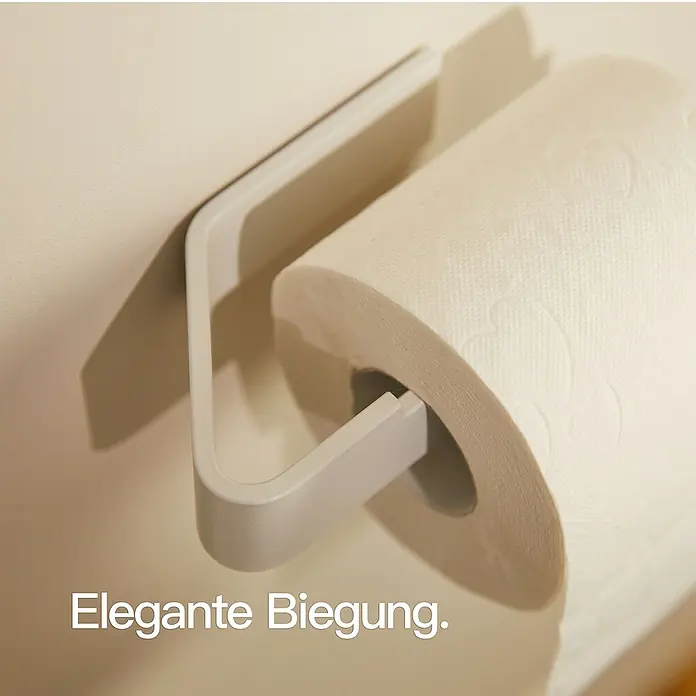 Designfabrik Hamburg Toilettenpapierhalter - Weiß, Matt - Elegante Biegung: Ein stilvoller Papierhandtuchhalter mit einer Rolle Papierhandtücher.