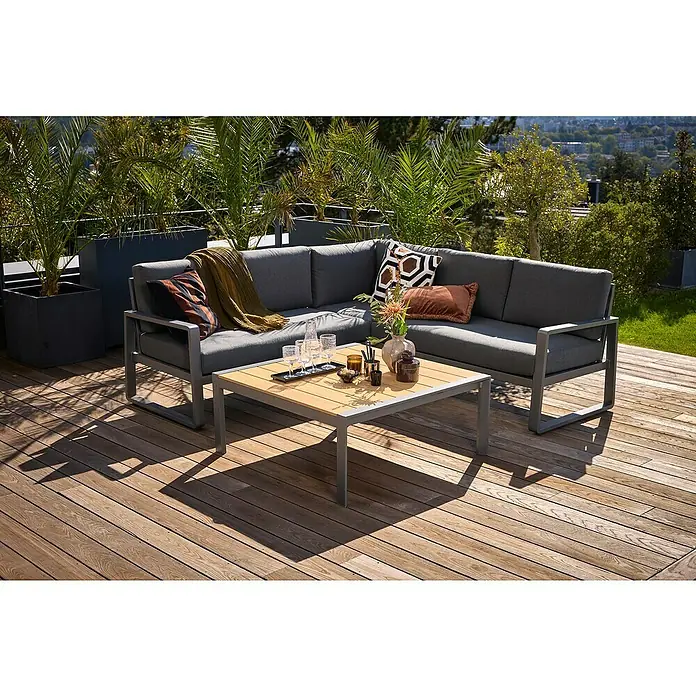 Sunfun Maja Loungetisch Holzoptik - L x B x H: 100 x 100 x 42 cm, Aluminium, Night-Grey - Elegante graue Lounge-Garnitur mit Couchtisch auf einer Holzterrasse, umgeben von Pflanzen. Ideal für entspannte Stunden im Freien.