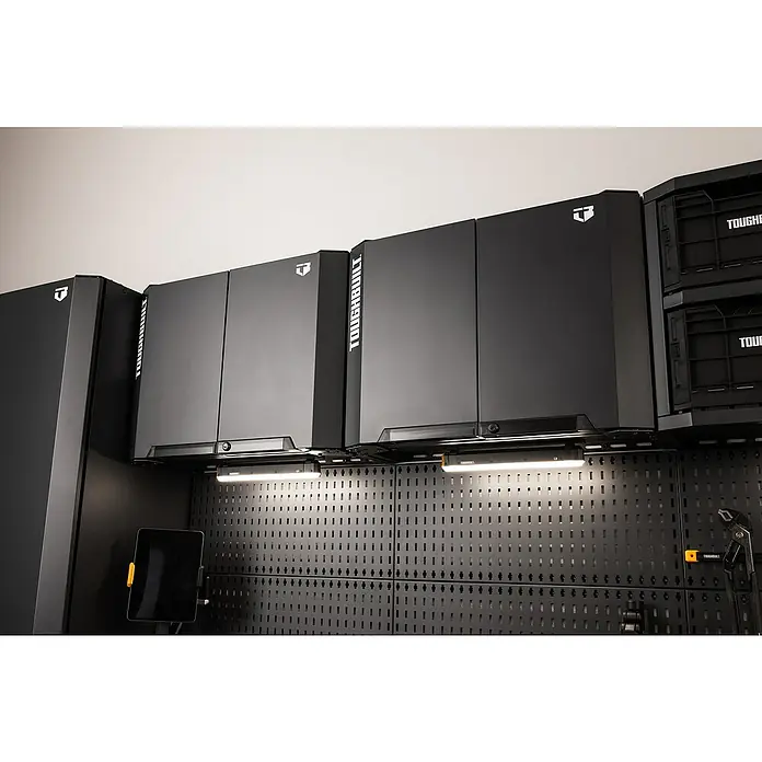 ToughBuilt Armario colgante - L x An x Al: 47 x 71 x 51 cm, Negro, Número de puertas: 2 ud. - Un primer plano de los armarios de taller Toughbuilt en una pared con panel perforado y luces LED, mostrando una solución de almacenamiento moderna.