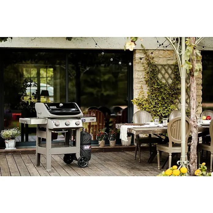 Weber Barbacoa de gas Spirit II E-310 + 7 accesorios - Superficie de la parrilla (An x Pr): 60 x 46 cm, 8,7 kW, Número de quemadores: 3 - Imagen de una parrilla de gas Weber en un patio, perfecta para asados de verano al aire libre.