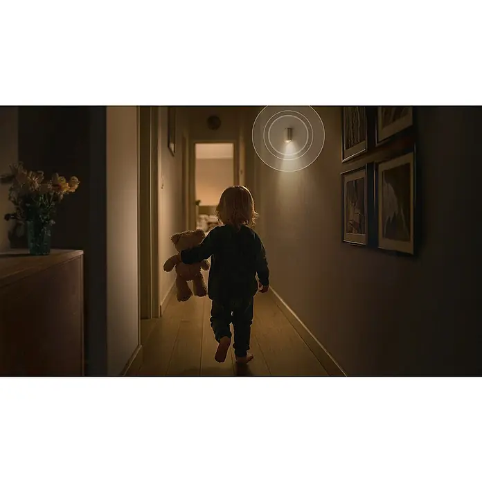Bosch Smart Home Bewegungsmelder II [+M] Matter - weiß - Kind mit Teddy im dunklen Flur, beleuchtet durch einen Bewegungsmelder. Sorgt für Sicherheit und Orientierung im Nacht.