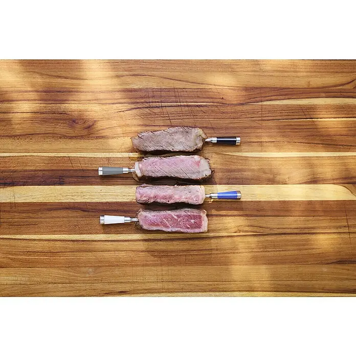 Weber Grill-Thermometer - L x B x H: 15 x 5,1 x 3,8 cm, Schwarz/Silber - Verschiedene Garstufen von Steak auf einem Holzbrett, von durchgebraten bis roh, aufgespießt auf farbigen Metallspießen.