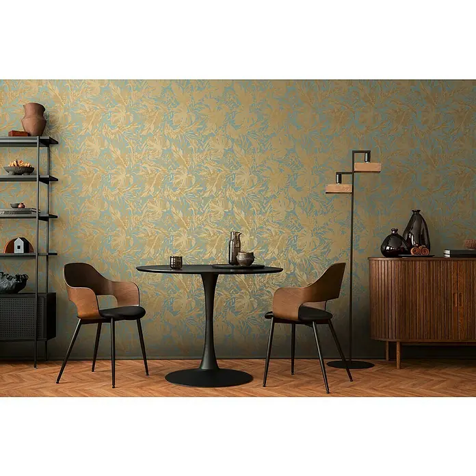 A.S. Création Cosmoliving by Cosmopolitan Vliestapete Blätter - Blau-Gold-Braun, Floral, 10,05 x 0,53 m - Nahaufnahme eines modernen Esszimmers mit einem schwarzen Tisch, Stühlen und dekorativen Akzenten vor einer blumigen Tapete.