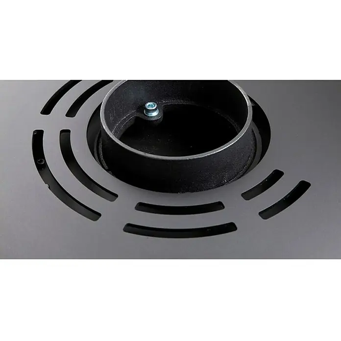 Aduro Kaminofen 9.3 Lux Air - 8 kW, Raumheizvermögen: 350 m³, Material Verkleidung: Stahl, Schwarz - Nahaufnahme einer schwarzen Metallabdeckung mit einem zylindrischen Einsatz und runden Schlitzen für Belüftung oder Design.