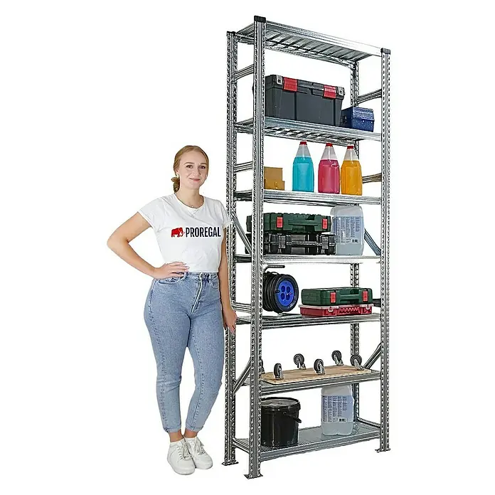 Proregal Metallregal Fachbodenregal PROXIMO 1x Grundregal + 3x Anbauregal - Traglast pro Boden: 200 kg, Anzahl Böden: 7 Stk., Stecken, Verzinkt - Ein hochauflösendes Bild eines Lagerregals voller Werkzeuge und Vorräte, daneben steht eine junge Frau zur Größenorientierung.