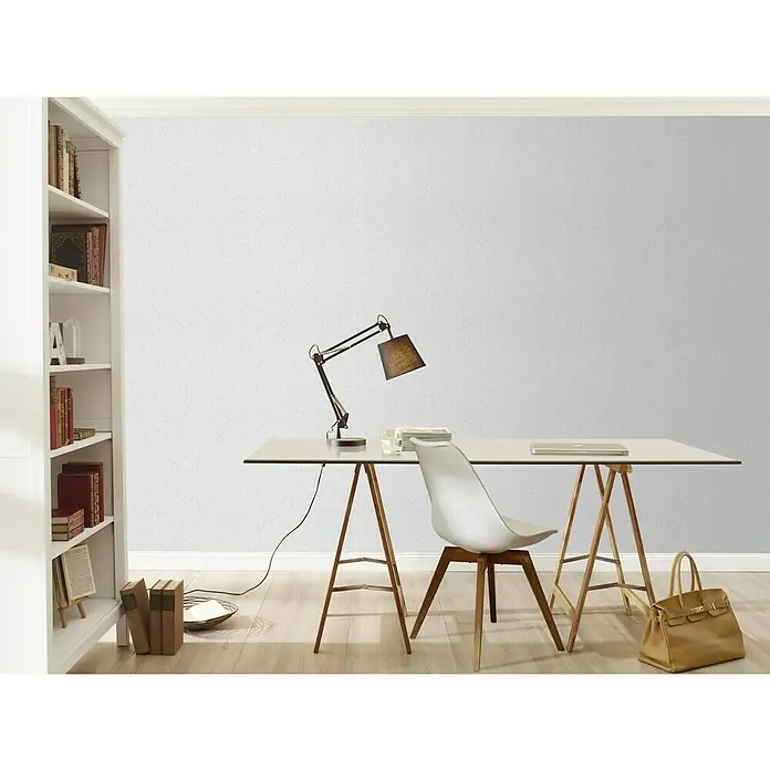 Rasch Papiertapete Prägeoptik - Weiß, Uni, 10,05 x 0,53 m - Ein moderner Arbeitsbereich mit einem minimalistischen weißen Schreibtisch, einer stilvollen Lampe und einem hellen Holzfußboden für Büro oder Homeoffice.