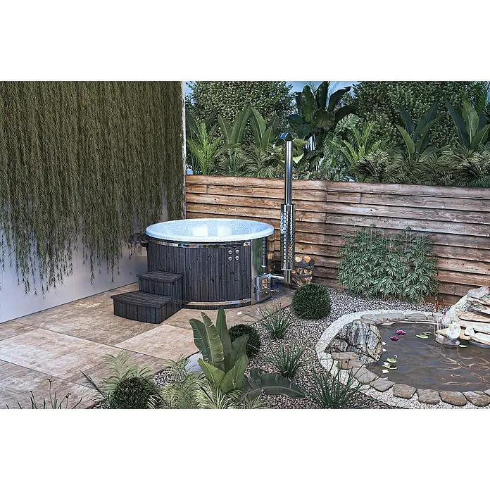 FinnTherm Hot Tub Stockholm "Spa Edition" Deluxe - 180 cm, Nordische Holz, Schwarz - Runder, holzbefeuerter Whirlpool mit Treppe in einem Garten mit Teich und Pflanzen.