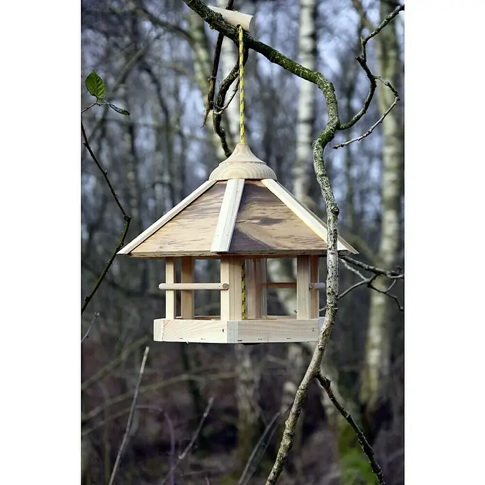 Dobar Sechseck-Vogelfutterhaus - 35 x 35 x 29 cm, Mit Silo - Ein hölzernes Vogelhaus hängt an einem Baum, mit einem pyramidenförmigen Dach und einer gelben Schnur zur Aufhängung.