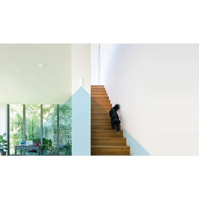 Bosch Smart Home Bewegungsmelder - Weiß, Reichweite ca.: 50 m - Das Bild zeigt einen Nest Rauchmelder an der Decke eines modernen Hauses mit einem Hund auf der Treppe.