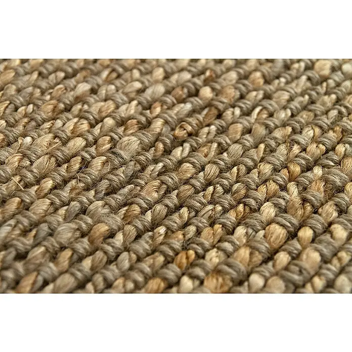 Alfombra de yute Málaga - Natural, 350 x 250 cm, 100% yute - Primer plano de una alfombra de sisal tejida, que muestra su textura y color natural. La alfombra añade calidez y un toque orgánico a cualquier espacio.