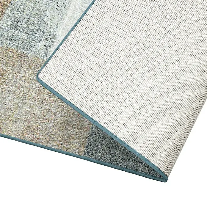 Teppichläufer Lucano - Braun, 200 x 80 cm, 100 % Polyamid - Detailansicht eines Teppichs mit blauem Rand, der eine rutschfeste Rückseite zeigt, ideal für sicheren Halt und Komfort in jedem Raum.