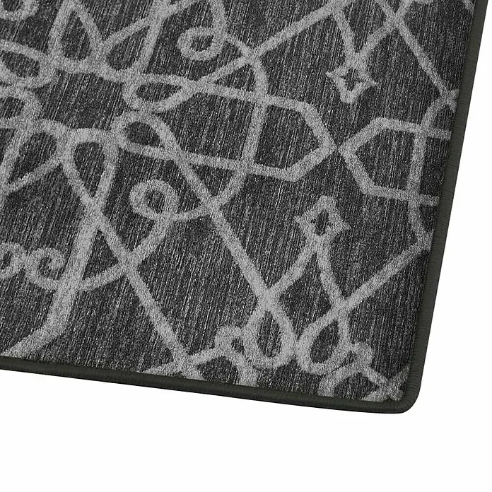 Teppichläufer Navelli - Schwarz, 150 x 80 cm, 100 % Polyamid - Detailaufnahme eines grauen Teppichs mit verschlungenem, hellem Muster und dunkler Umrandung. Elegantes Design für jeden Raum.