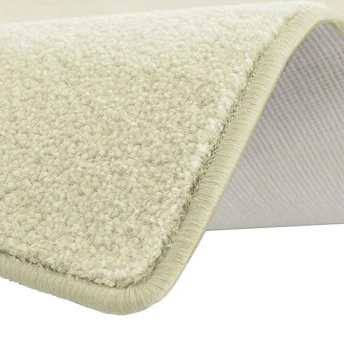 Kurzflorteppich Dynasty - Creme, 100 x 100 cm, 100 % Polypropylen - Nahaufnahme einer beigen Teppichmatte mit strukturierter Oberfläche und abgerundeten Kanten, die eine weiche Textur und eine robuste Konstruktion zeigt.