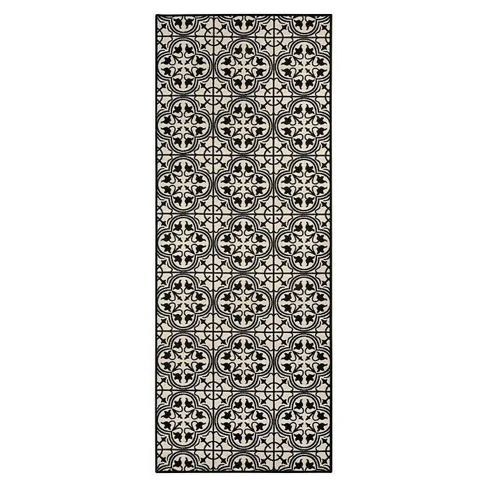 Teppichläufer Galway - Schwarz/Creme, 300 x 80 cm, 100 % Polyamid - Nahaufnahme einer dekorativen Bodenmatte mit einem stilvollen, schwarz-weißen floralen Muster, ideal für Innenräume.