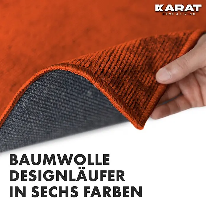 Teppichläufer Azade - Terra, 250 x 80 cm, 65 % Baumwolle, 35 % Polyester - Nahaufnahme eines orangefarbenen Baumwollteppichs von Karat Home & Living, der die Textur und Verarbeitung des Teppichs zeigt.