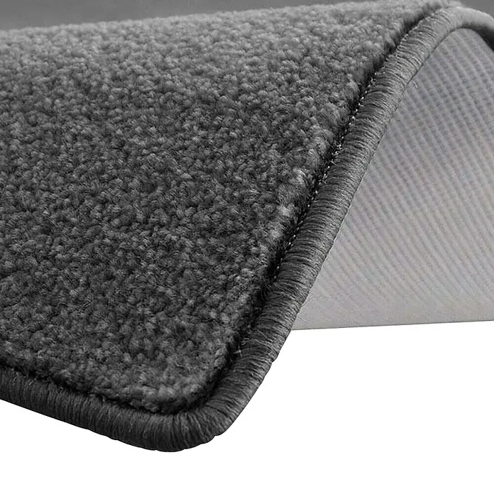 Kurzflorteppich Dynasty - Anthrazit, 100 x 100 cm, 100 % Polypropylen - Detailaufnahme eines grauen Teppichs mit sauberer Kante und sichtbarer Rückseite, ideal für stilvolle und komfortable Bodenbeläge.
