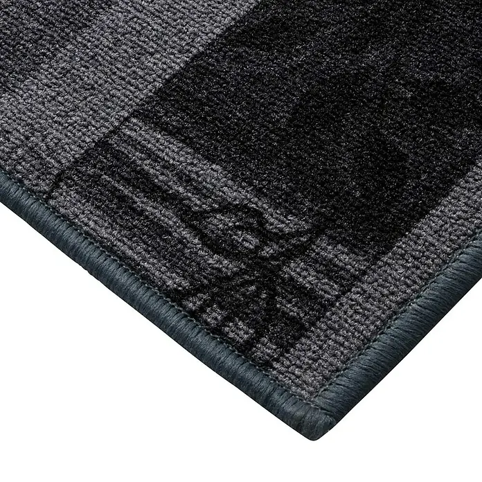 Teppichläufer Akzent - Grau, 100 x 67 cm, 100 % Polyamid - Nahaufnahme einer grauen Fußmatte mit dunklen Streifen und einem subtilen Logo in der Ecke, ideal für den Eingangsbereich.