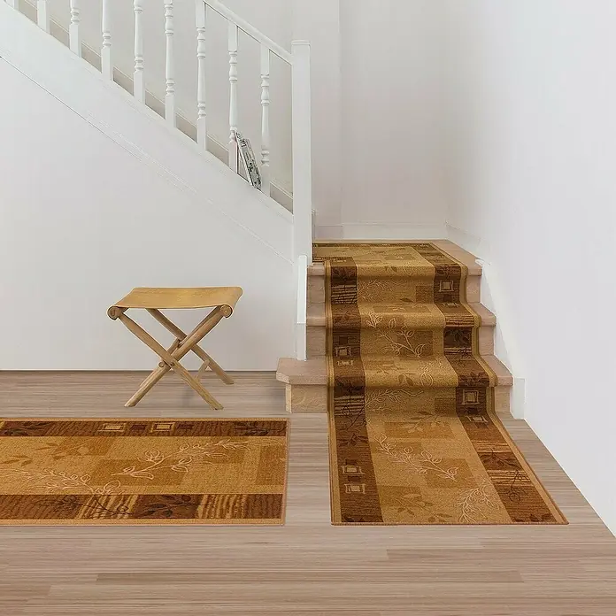 Teppichläufer Akzent - Beige, 150 x 67 cm, 100 % Polyamid - Bild einer Treppe mit einem beigefarbenen Läufer mit floralem Muster und einem passenden Teppich. Ein hölzerner Klapphocker steht daneben.