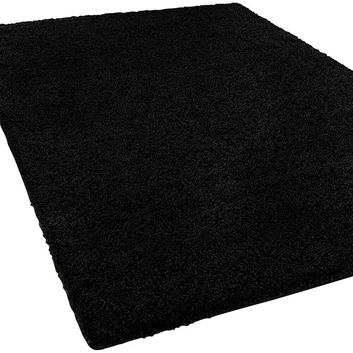 Hochflorteppich Barcelona - Schwarz, 450 x 200 cm, 100 % Polypropylen - Nahaufnahme eines rechteckigen, schwarzen Shaggy-Teppichs mit einer weichen, flauschigen Textur, ideal für Wohnräume, die Komfort und Stil suchen.