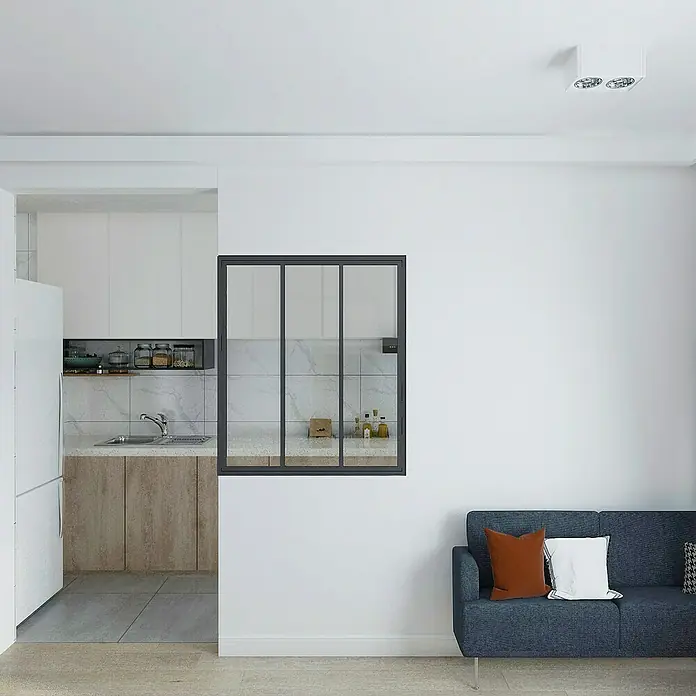 Inova Aluminiumfenster Loft Innenfenster Glas - 930 x 1.080 mm - Blick auf eine modern gestaltete Küche durch ein Fenster, das den Wohnraum mit einer Couch verbindet. Helle und einladende Atmosphäre.