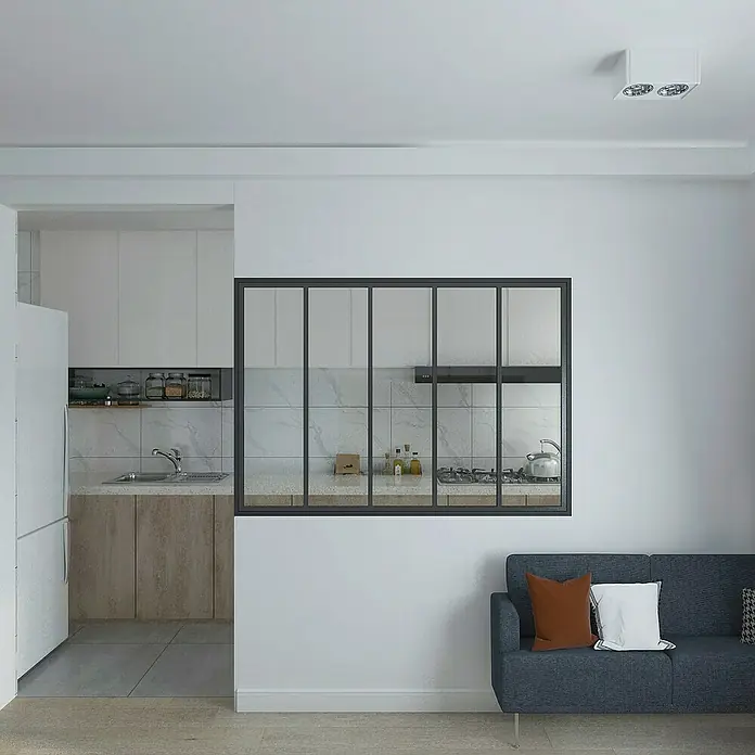 Inova Aluminiumfenster Loft Innenfenster Glas - 1.530 x 1.080 mm - Ein modernes Wohnzimmer mit Blick auf eine Küche durch ein Fenster mit schwarzen Rahmen. Ein graues Sofa lädt zum Entspannen ein.