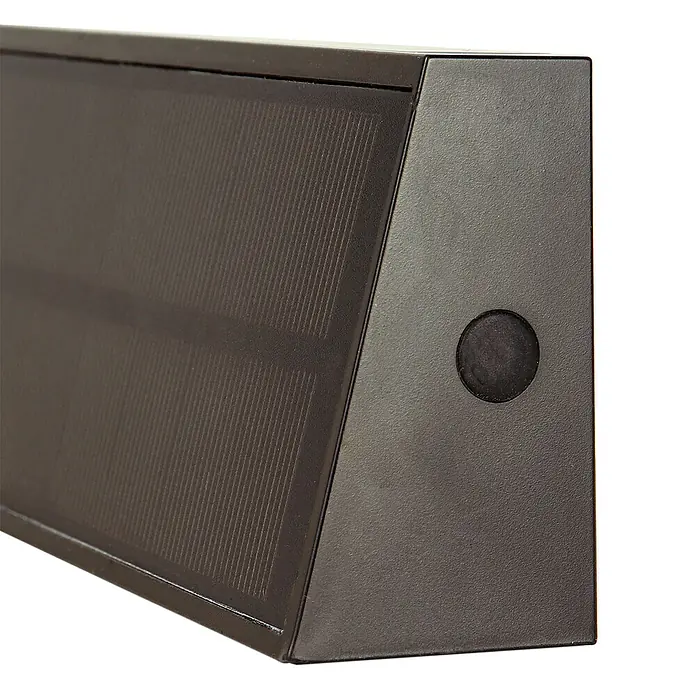 Arte confort Aplique solar para exterior Trape - 1,3 W, Blanco neutro, Negro - Primer plano de una lámpara solar marrón con un sensor redondo en el lado derecho, ideal para espacios exteriores.