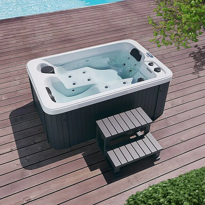 Home Deluxe Außen-Whirlpool HORIZON inkl. Treppe und Thermoabdeckung - Weiß, Max. Personenzahl: 2 Stk. - Hochwinkelaufnahme eines Whirlpools mit Trittstufen auf einer Holzterrasse, ideal zum Entspannen im Freien.