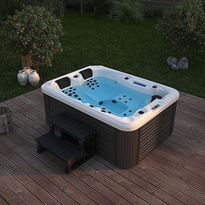 Home Deluxe Outdoor Whirlpool BEACH Mit Treppe und Thermoabdeckung -  - Ein rechteckiger Whirlpool mit Treppe steht auf einer Holzterrasse. Das blaue Wasser lädt zum Entspannen ein.