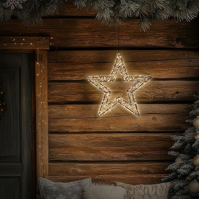 ECD Germany LED-Weihnachtsdekoleuchte Weihnachtsdeko Drahtstern Weihnachtsstern Dekostern für Weihnachten - 8 x 38 x 38 cm, Schwarz, Netzbetrieben, LED - Ein strahlender, beleuchteter Stern hängt an einer rustikalen Holzwand und verbreitet festliche Stimmung mit seinem warmen Licht.