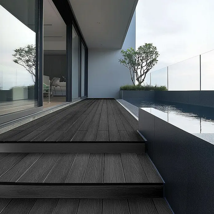 Home Deluxe Terrassenfliese SAMANA PREMIUM 30m² - Anthrazit, Matt - Außenaufnahme einer Terrasse mit dunklen Holzdielen und Treppe, die zu einem Pool führt. Elegantes Design für den Außenbereich.