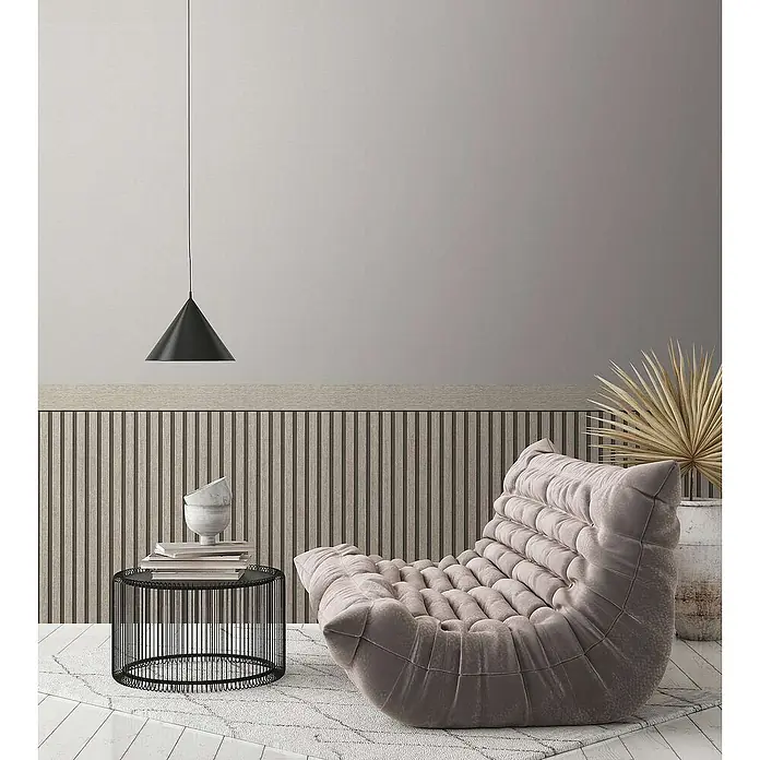 Tadessi Vliestapete 0 - Grau, Streifen, 5 x 1,06 m - Ein bequemer, hellbeiger, getufteter Loungesessel in einem modernen Wohnzimmerambiente.