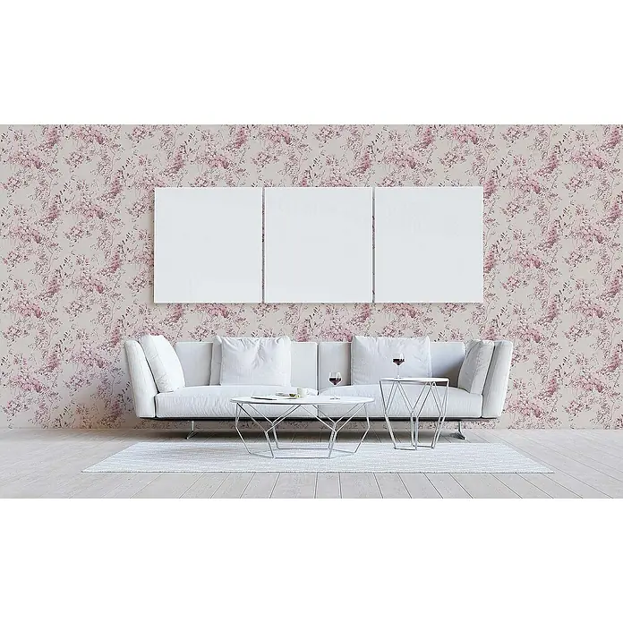 Tadessi Vliestapete M1-No.1301 - Rosa, Floral - Rosa geblümte Tapete an einer Wohnzimmerwand, davor ein weißes Sofa und Tische. Drei leere Leinwände hängen darüber.