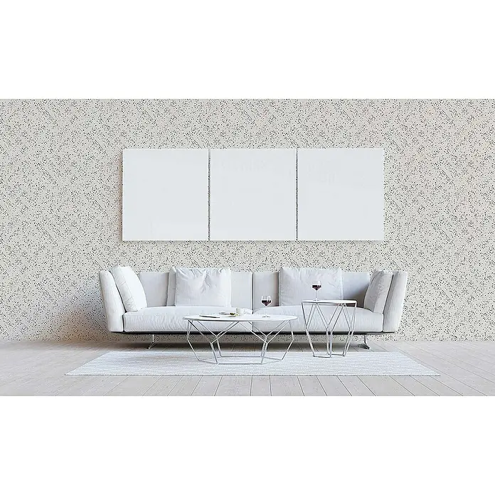 Tadessi Vliestapete M1-No.1657 - Schwarz, Grafisch, 10,05 x 0,53 m - Helle gesprenkelte Tapete an einer Wohnzimmerwand hinter weißem Sofa und Tischen.