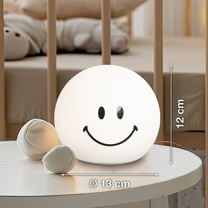 FHL easy LED-Nachtlicht GlowMoji - 0,7 W, L x B x H: 13 x 13 x 12 cm, RGBW, Glowmoji White - Lächelnde Tischleuchte für Kinderzimmer. Die Lampe ist weiß mit einem schwarzen Smiley-Gesicht. Durchmesser: 13 cm, Höhe: 12 cm.