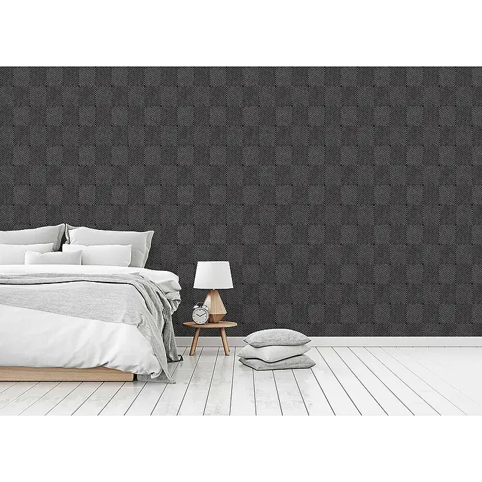 Tadessi Vliestapete M1-No.1587 - Schwarz, Grafisch, 10,05 x 0,53 m - Dunkelgraue Tapete mit wiederholtem geometrischem Muster aus konzentrischen Rauten an einer Schlafzimmerwand.