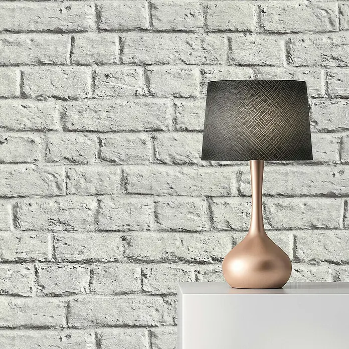 Tadessi Vliestapete M1-No.271 - Grau, Steinoptik, 10,05 x 0,53 m - Eine stilvolle Tischlampe mit roségoldenem Fuß und dunklem gemusterten Schirm.