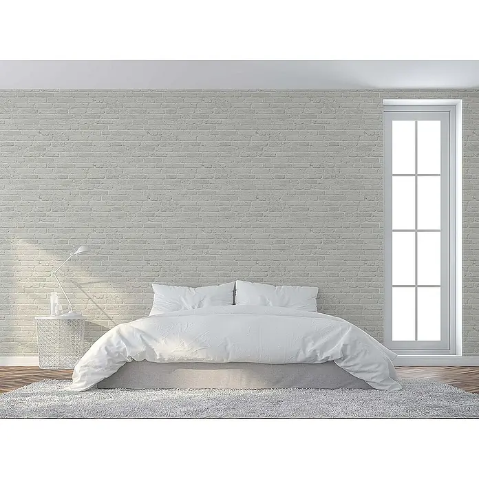 Tadessi Vliestapete M1-No.110 - Grau, Steinoptik, 10,05 x 0,53 m - Hellgraue Backsteinmuster-Tapete an einer Wand in einem hellen Schlafzimmer.