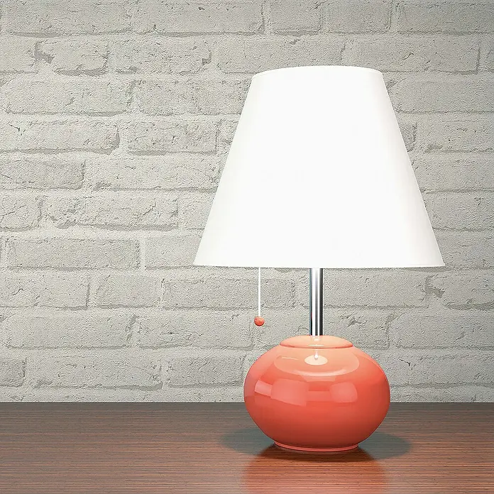 Tadessi Vliestapete M1-No.110 - Grau, Steinoptik, 10,05 x 0,53 m - Glänzende korallfarbene Tischlampe mit weißem konischem Schirm auf einem polierten Holztisch.