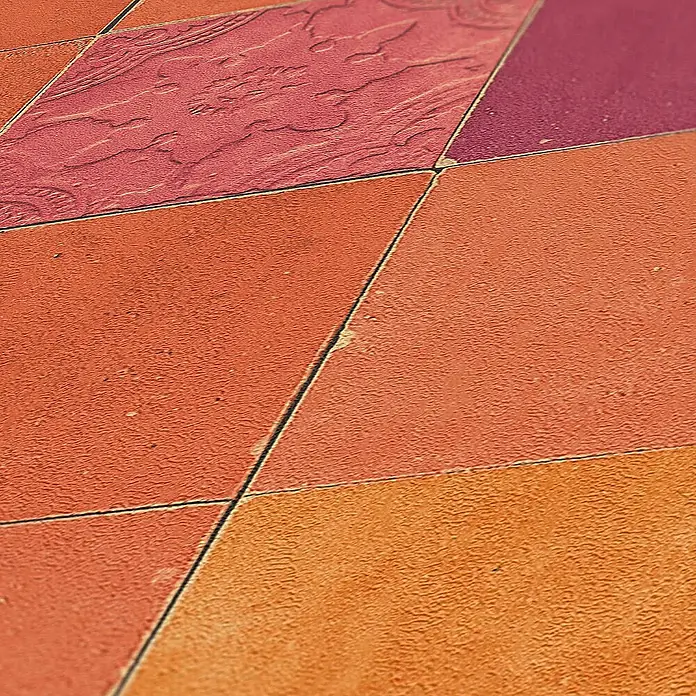 Tadessi Vliestapete M1-No.1663 - Rot, Fliesenoptik, 10,05 x 0,53 m - Strukturierte Bodenfliesen in verschiedenen Orange-, Rot- und Violetttönen. Eine rote Fliese hat ein erhabenes Muster.