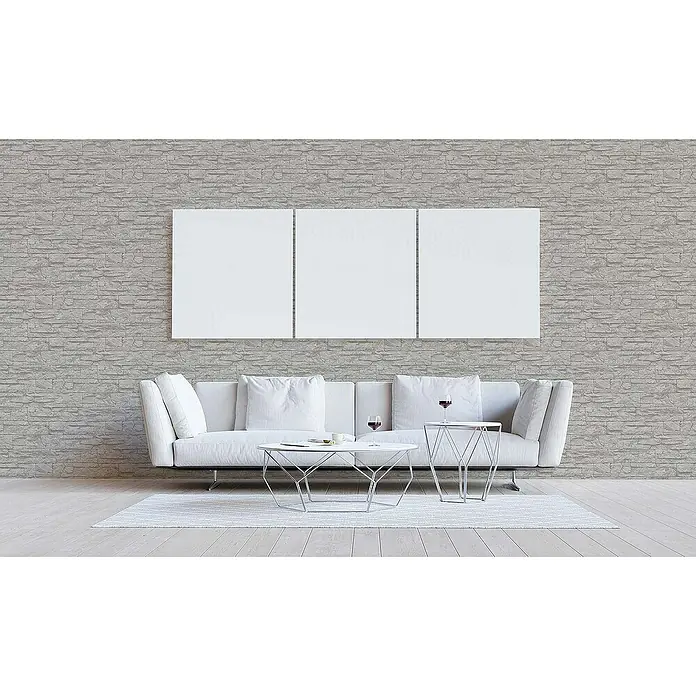 Tadessi Vliestapete M1-No.850 - Grau, Steinoptik, 10,05 x 0,53 m - Graue Ziegelmuster-Tapete in einem modernen Wohnzimmer, hinter einem weißen Sofa und dreiteiliger Kunst.