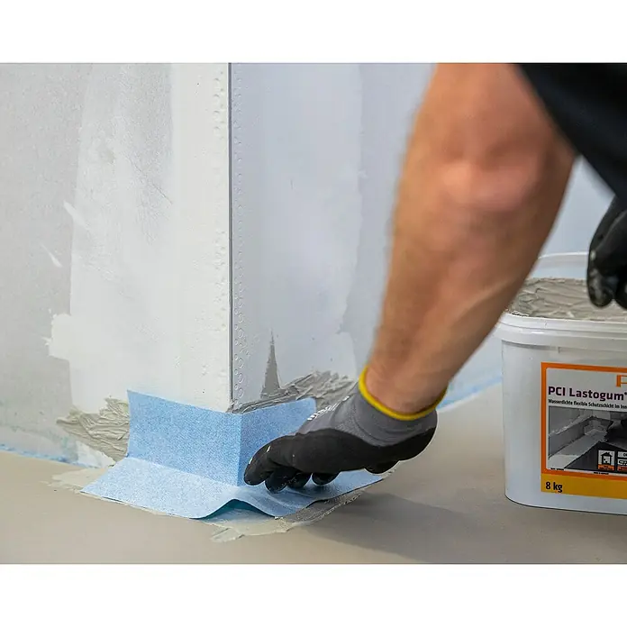 PCI Pecitape Dichtecke 90° Außen - Außenecke, 1 Stk. - PCI Lastogum Abdichtung: Ein Handwerker dichtet mit flexibler Dichtschlämme eine Ecke ab, um das Badezimmer wasserfest zu machen.