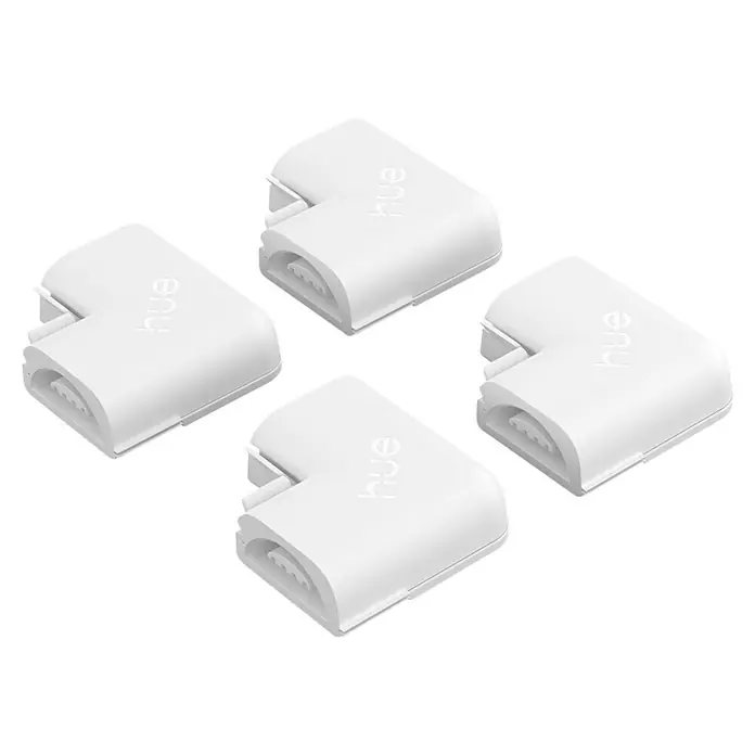Philips Hue Eckverbinder-Set Flux - Weiß - Nahaufnahme von vier weißen Philips Hue Lightstrip Eckverbindungsstücken auf einem schwarzen Hintergrund.