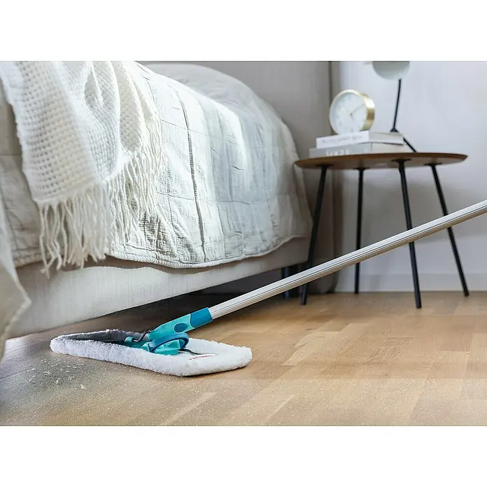 Leifheit Ersatz-Bezug Staubbezug Superduster Floor XL - Weiß, Passend für: Leifheit Bodenwischer Profi XL - Der Leifheit Wischmop im Einsatz auf einem Holzboden unter einem Bett, ideal für die schnelle und effiziente Reinigung des Zuhauses.
