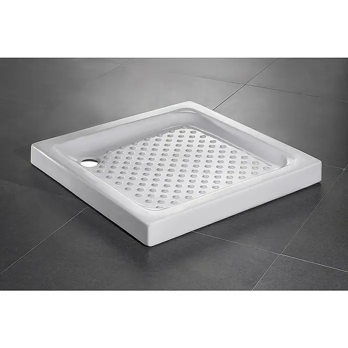 Plato de ducha porcelánico - L x An: 80 x 80 cm, Porcelana sanitaria, Blanco - Plato de ducha cuadrado de cerámica blanca con superficie texturizada y desagüe lateral sobre baldosas oscuras.