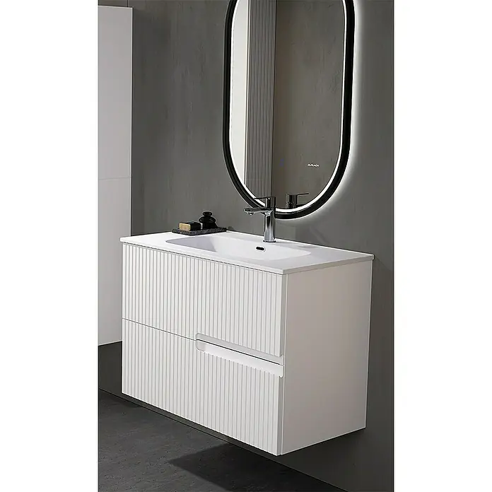 Duplach Mueble bajo de lavabo Mana - L x An x Al: 45 x 80 x 60 cm, Blanco - Un tocador moderno con cajones acanalados y un espejo iluminado en un baño.